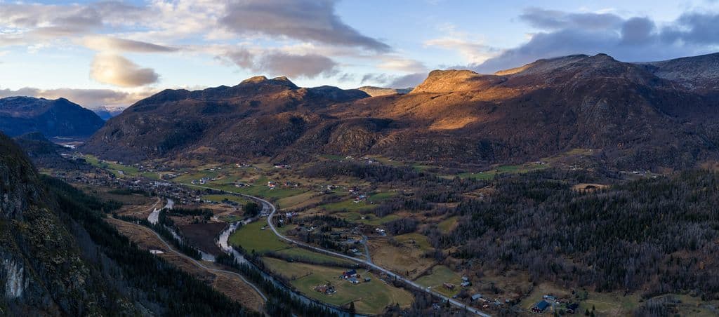Ultra-wide panorama of Hemsedal valley in late shadow with last golden light on upper slopes, Hallingdal Norway